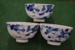 A set of three Chinese blue and white tea bowls.