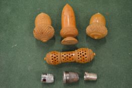 A collection of 19th century carved coquilla nut sewing accessories.