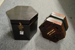 A Wheatstone System mahogany accordion, in a wooden travelling box.