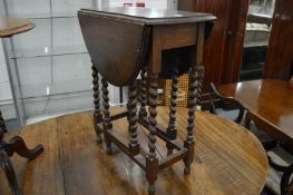 A small oak drop-leaf gate-leg table.
