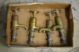 Two pairs of old brass taps.