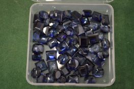 A box of sapphire coloured stones.