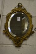 A small cast brass framed decorative mirror.