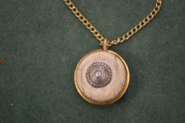 A silver gilt pendant on chain.