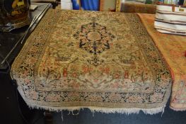 A Persian silk rug, beige ground with floral decoration.