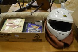 An old crash helmet and car related books.