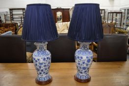 A pair of Chinese style blue and white vase lamps.