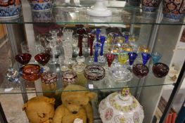 A shelf of colourful glassware.