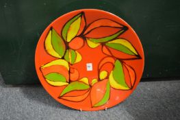 A good large Poole Pottery Delphis charger, orange ground with stylized decoration, shape no. 54,