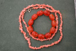 A coral necklace and an amber style bracelet.