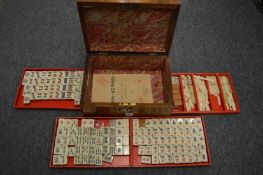 A Mahjong set in a Victorian walnut sewing box.