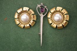A pair of gilt metal ear clips and a plaid brooch.