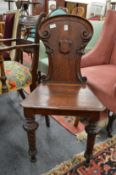 A Victorian oak hall chair.
