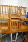 A kitchen drop-leaf gate-leg table with four chairs.