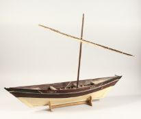 A MODEL OF A DHOW. 33ins long on a stand.