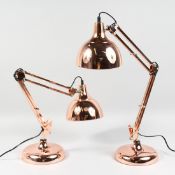 A PAIR OF COPPER ANGLE POISE LAMPS.