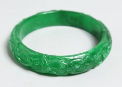 A CARVED JADE BANGLE 2.75ins .