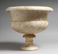 A CARVED ALABASTER PEDESTAL BOWL on two parts with a sockle base. 10.5ins high.