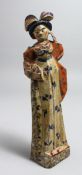 A PRIMITIVE CARVED WOOD AND PAINTED FEMALE FIGURE, possibly American. 10ins long.