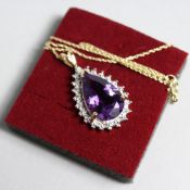 A 9CT GOLD AMETHYST AND DIAMOND PENDANT AND CHAIN.