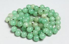 A STRING OF JADE BEADS.