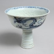 A CHINESE BLUE AND WHITE STEM CUP with blue dragons.
