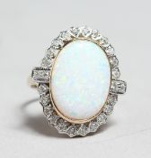 A GOOD 9CT GOLD OPAL AND DIAMOND OVAL RING.