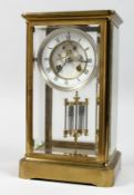 A BRASS FOUR GLASS MANTLE CLOCK with eight day movement striking on a bell, enamel dial with Roman