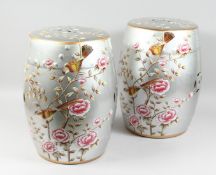 A PAIR OF CHINESE PORCELAIN SILVERED BARREL SEATS painted with flowers. 18ins high.