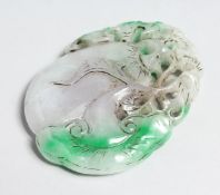 A TWO TONED CARVED JADE PENDANT with seal mark 3.25ins.
