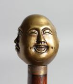 A WALKING STICK with carved bone handle of four child's faces.