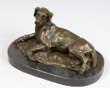 A BRONZE DOG. Signed, 11ins on a marble base.