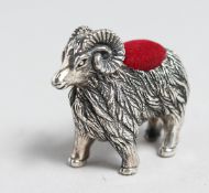 A SILVER RAM PIN CUSHION.