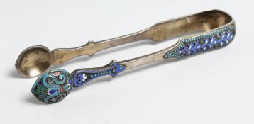 A PAIR OF RUSSIAN SILVER AND ENAMEL SUGAR TONGS. 13.5ins long. Mark 88, B. C. over 1887.