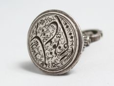 A HEAVY ISLAMIC BELL SHAPED SEAL PENDANT. 4.5ins long.