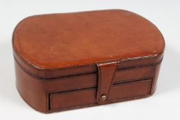 A TAN LEATHER JEWELLERY BOX.