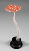 A MUSHROOM SPECIMEN, 9ins high, on a circular base.