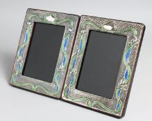 A PAIR OF SILVER AND ENAMEL PHOTOGRAPH FRAMES. 7.5ins x 5.5ins.