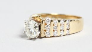 A SUPERB 14CT GOLD DIAMOND RING with four row diamond shoulders.