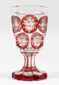 A GOOD BOHEMIAN GOBLET with eleven ruby panels of flowers. 6ins high.