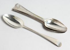 FOUR EARLY GEORGE II RAT TAIL DESSERT SPOONS.