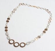 A 9CT WHITE GOLD AND ROSE GOLD DISC NECKLACE.