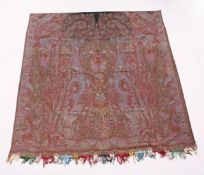 A GOOD LARGE KASHMIR TEXTILE, woven in reds and greens to a Paisley design. 11ft 4ins x 5ft 3ins.