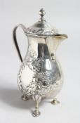A GOOD HELMET SHAPED CREAM JUG AND COVER with floral decoration, on three pad feet.