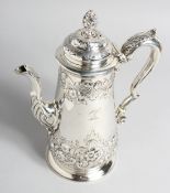 A GOOD VICTORIAN COFEE POT with chased and repousse decoration, accanthus handles and pineapple