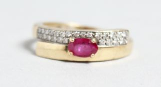 A 14CT GOLD, RUBY AND DIAMOND CROSSOVER RING