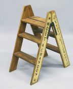 A PAINTED WOOD LADDER with champagne names.