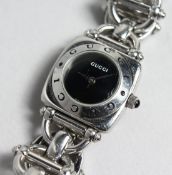 A GUCCI BLACK FACED WRIST WATCH.