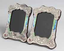 A PAIR OF SILVER AND ENAMEL PHOTOGRAPH FRAMES. 8.5ins x 6ins..
