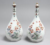 A PAIR OF 18TH CENTURY KAKIEMON OCTAGONAL BOTTLE VASES AND COVERS. 8ins high.